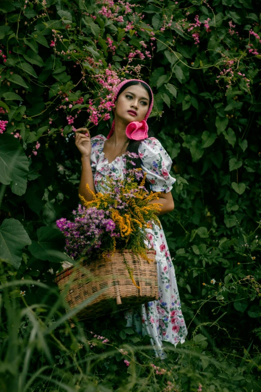 a beautiful woman holding onto a basket of flowers