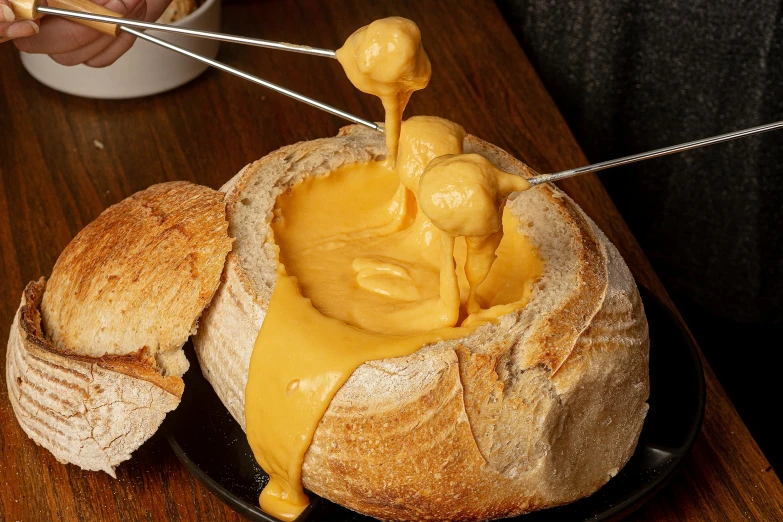 a hand drizzing peanut er onto bread