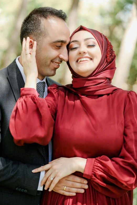 a man and woman hugging while holding each other