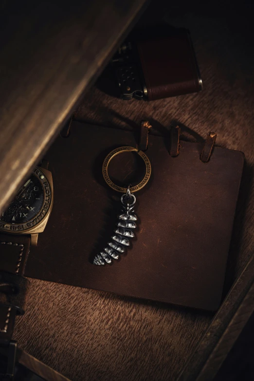 a watch and a spiral key on top of brown cloth