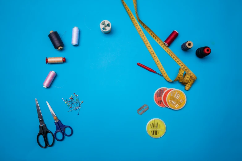 a collection of various sewing supplies sitting on a table