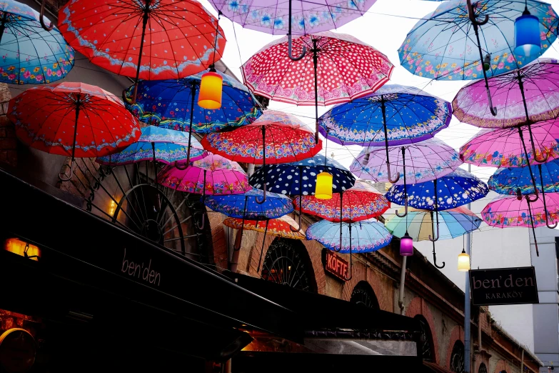a group of bright colored umbrellas that have been hung
