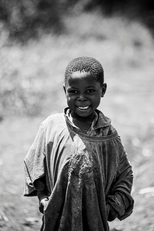 a child is posing for a picture outside