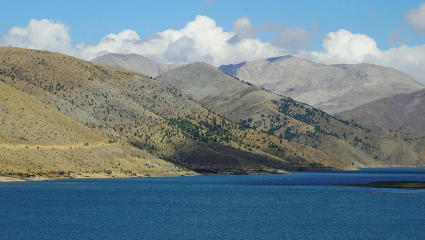 the hills surrounding the blue body of water