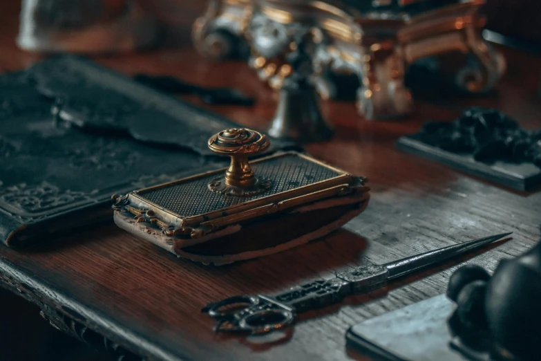 several tools sit on the table beside a book