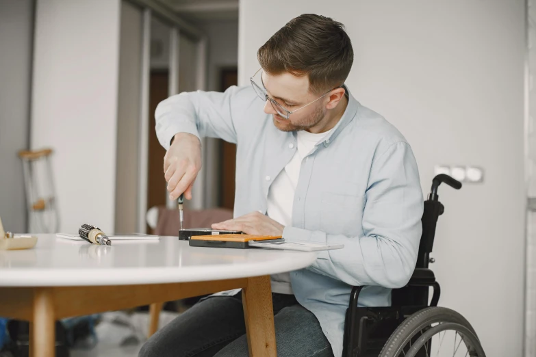 a man in a wheelchair is putting food into a plate