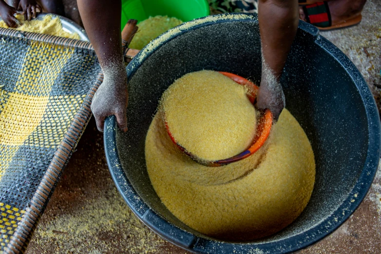 person putting food in a big blue bowl