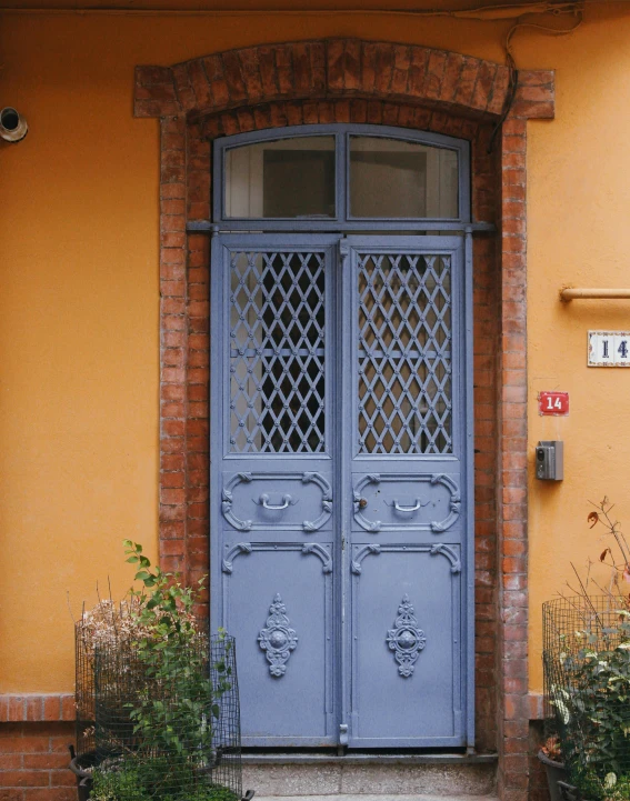 two blue doors are open in front of a house