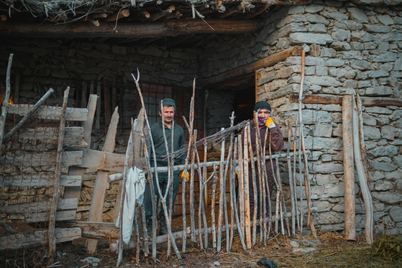 two men with hats on their head standing in front of a building