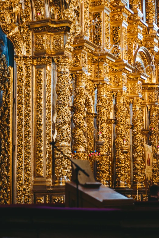 an intricate golden architecture on the side of a building