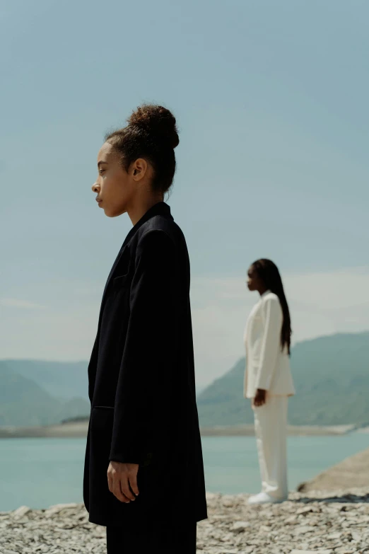 two women on the beach looking at soing