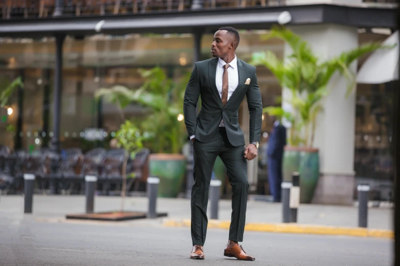 a man wearing a suit and standing in the middle of a street