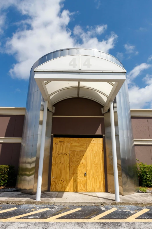 two large wooden doors in an outside concrete structure