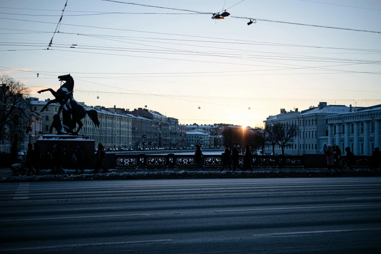 a lone rider jumping a horse in a city