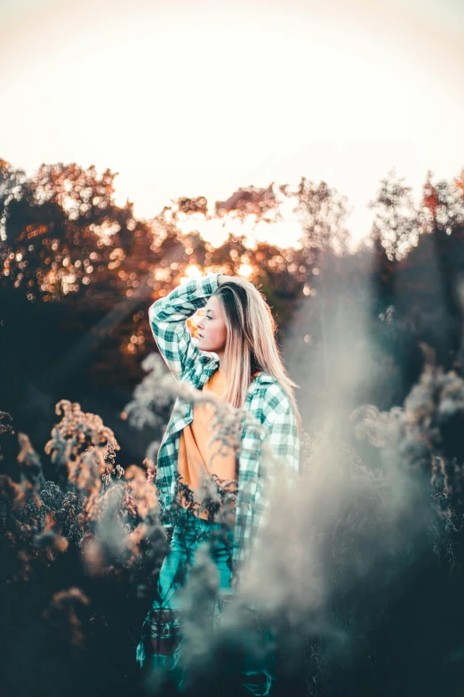 woman standing alone surrounded by the grass