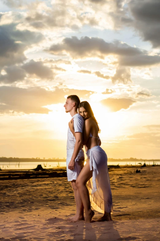 the two people are standing on the beach