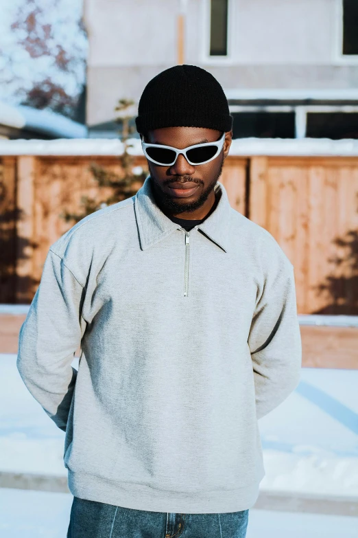 a man in glasses is standing in the snow