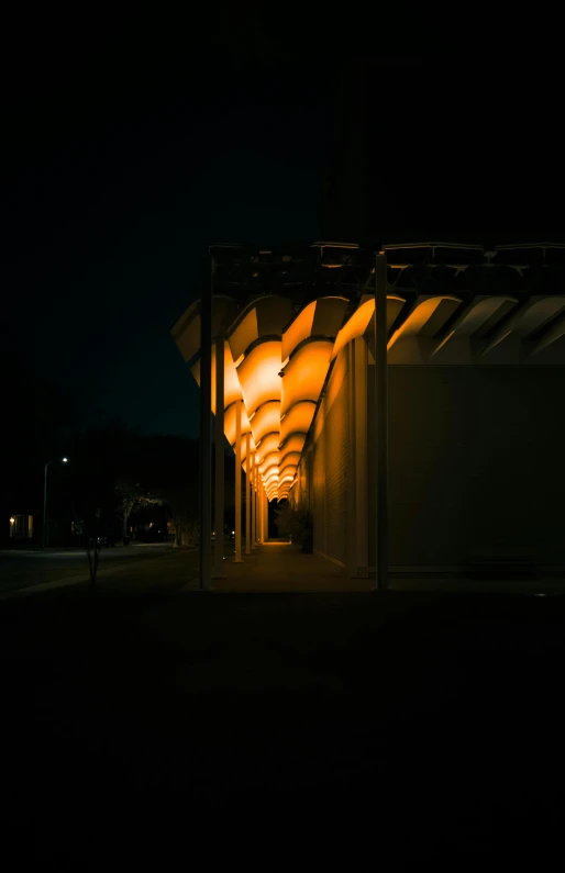 a dimly lit walkway in the middle of the night