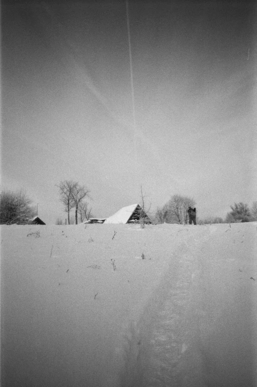 black and white pograph of a farm in snow