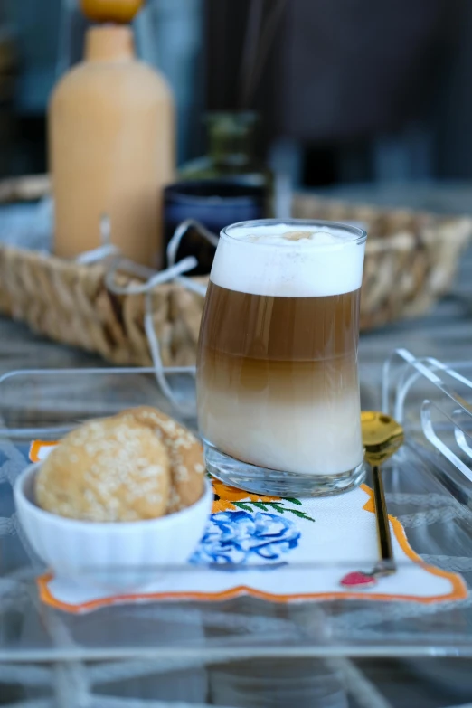 a cup with drinks and an individual on a tray