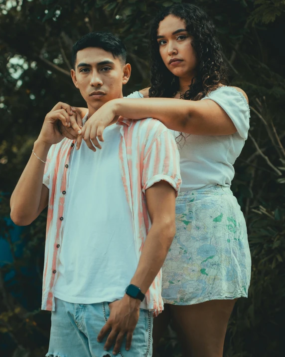 an adult woman touching a young man's shoulder