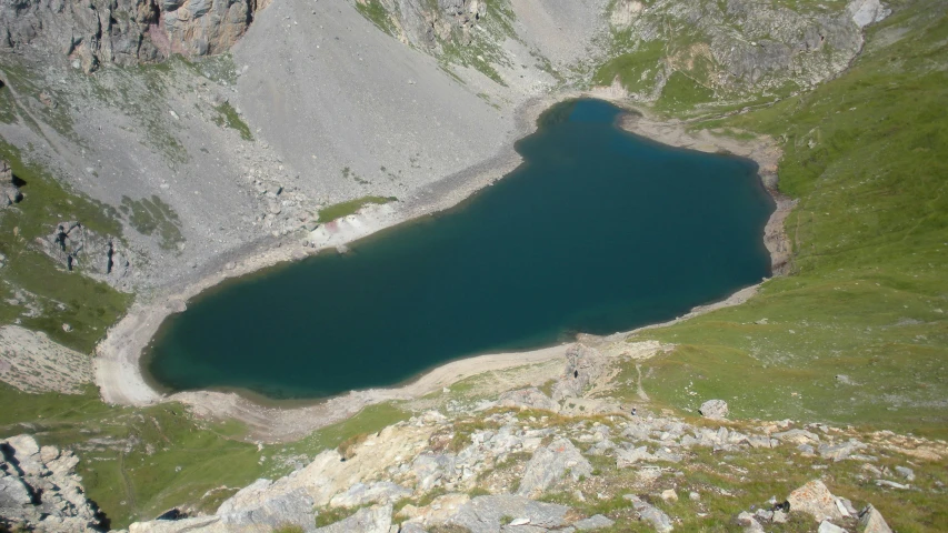 a mountain lake sitting in the middle of a valley