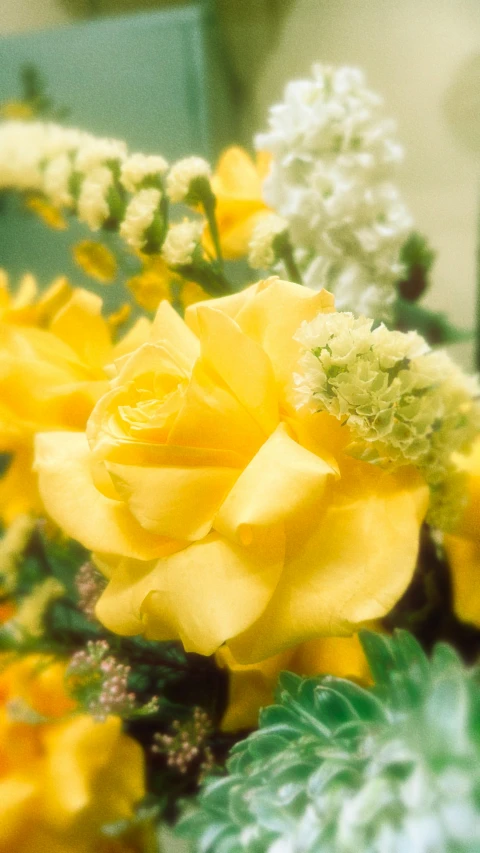 some very pretty yellow flowers in a bouquet