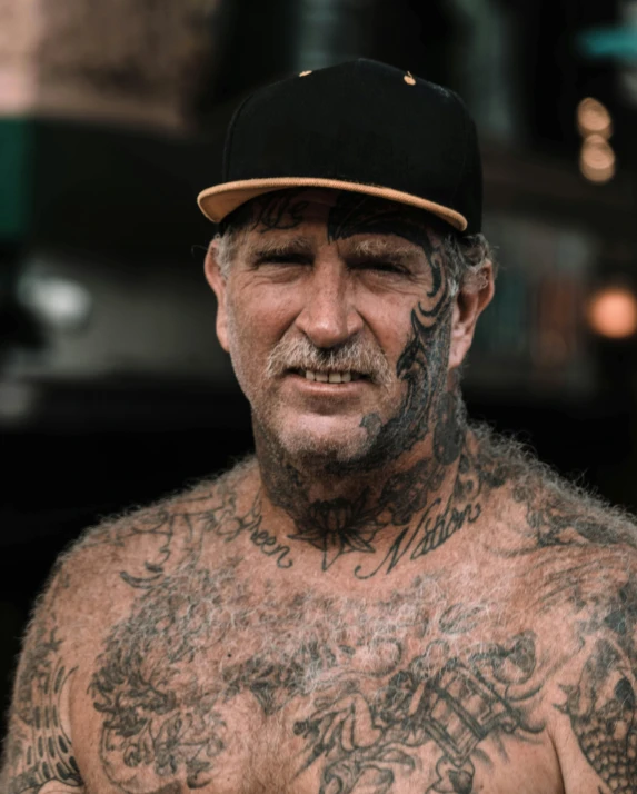 an old man with tattoos on his body