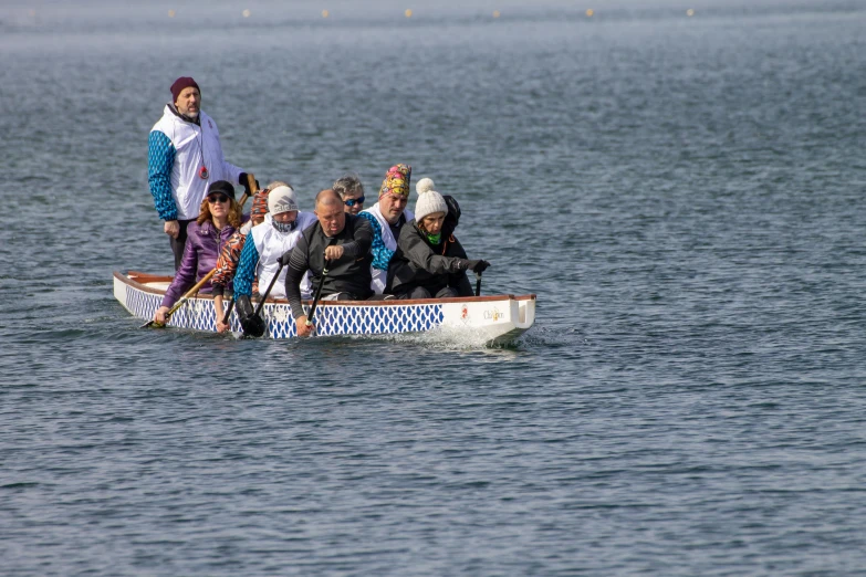 several people are on the water rowing a boat