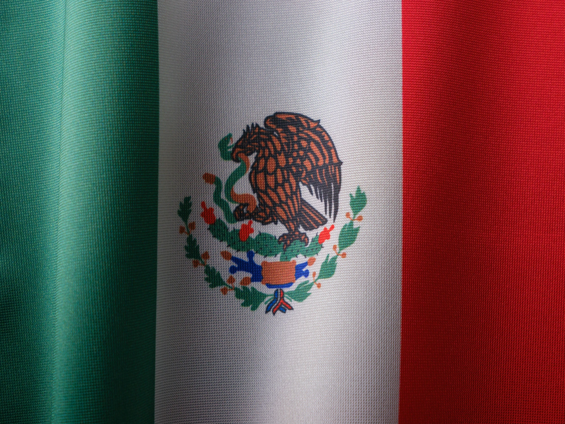 three flags in one pograph with a very dark red, white and green backdrop