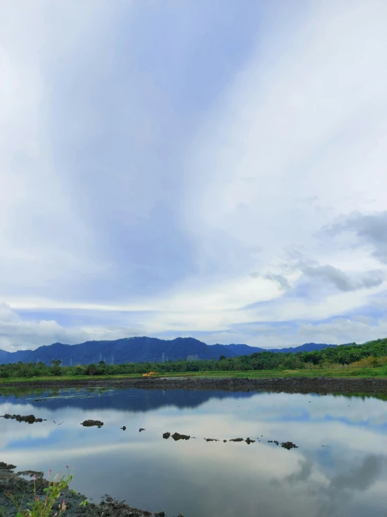 an image of a scenic pond with clouds in the sky