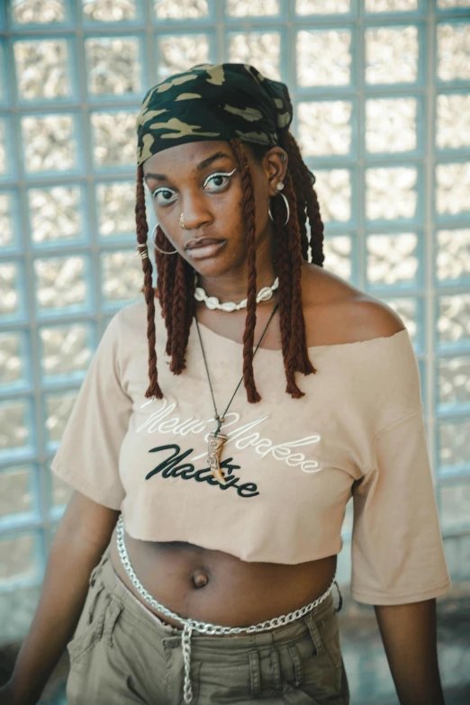 a woman wearing short pants and a shirt with dreadlocks