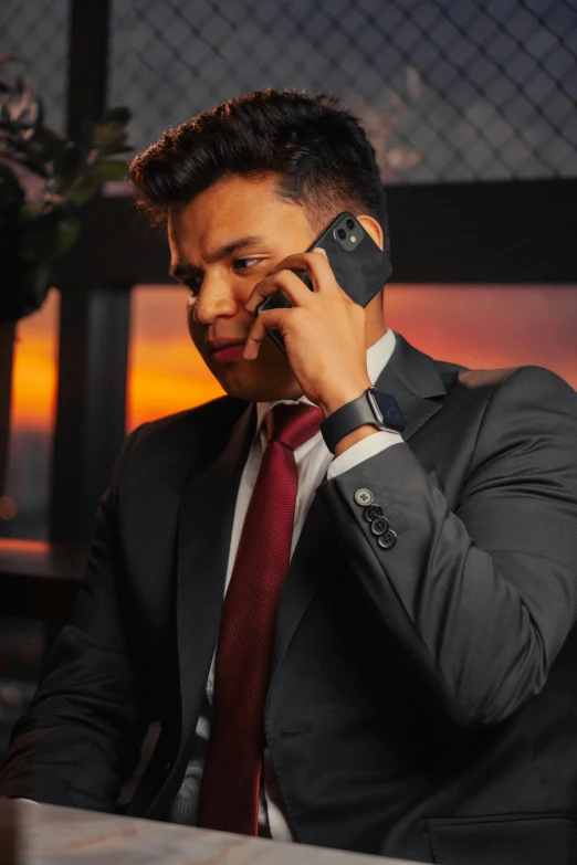 a man in a business suit talking on his cell phone