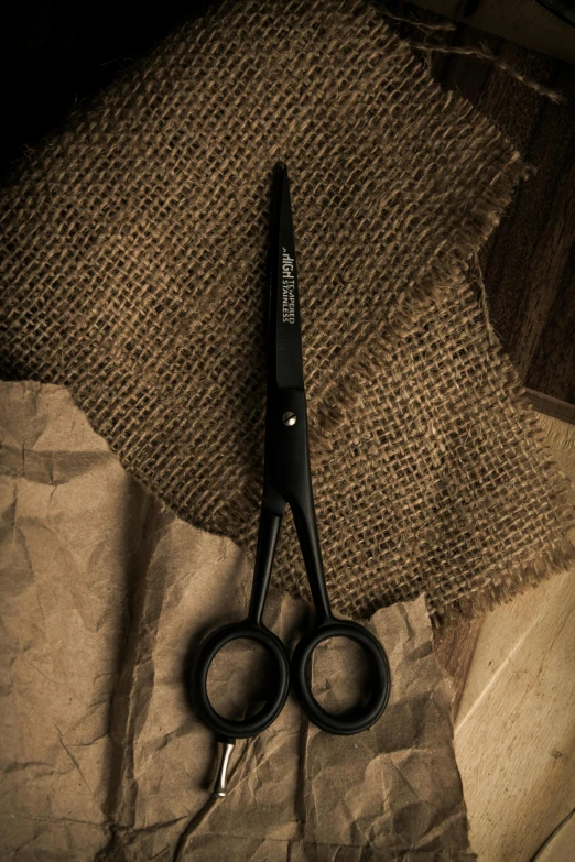 a pair of scissors on top of burlap