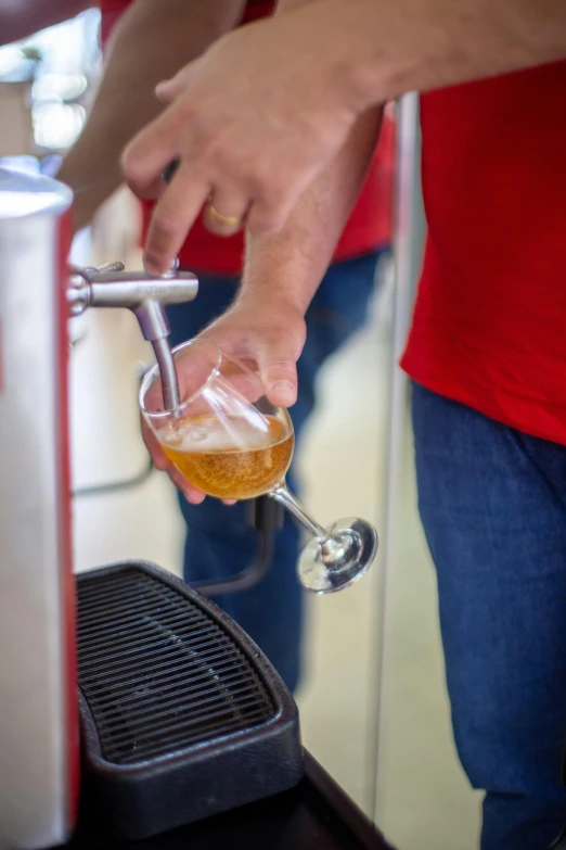 someone is pouring a beer into a glass