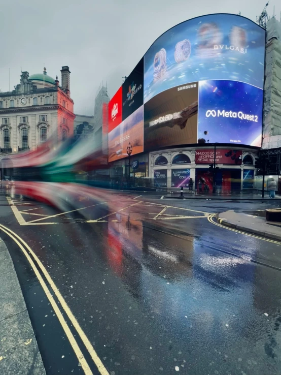 a large billboard on a city street with a very wet floor