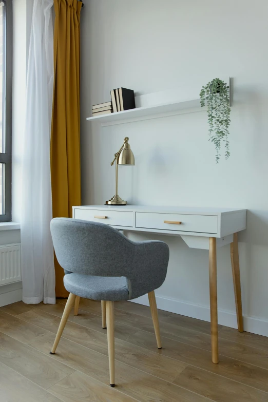 an office desk with a lamp next to it