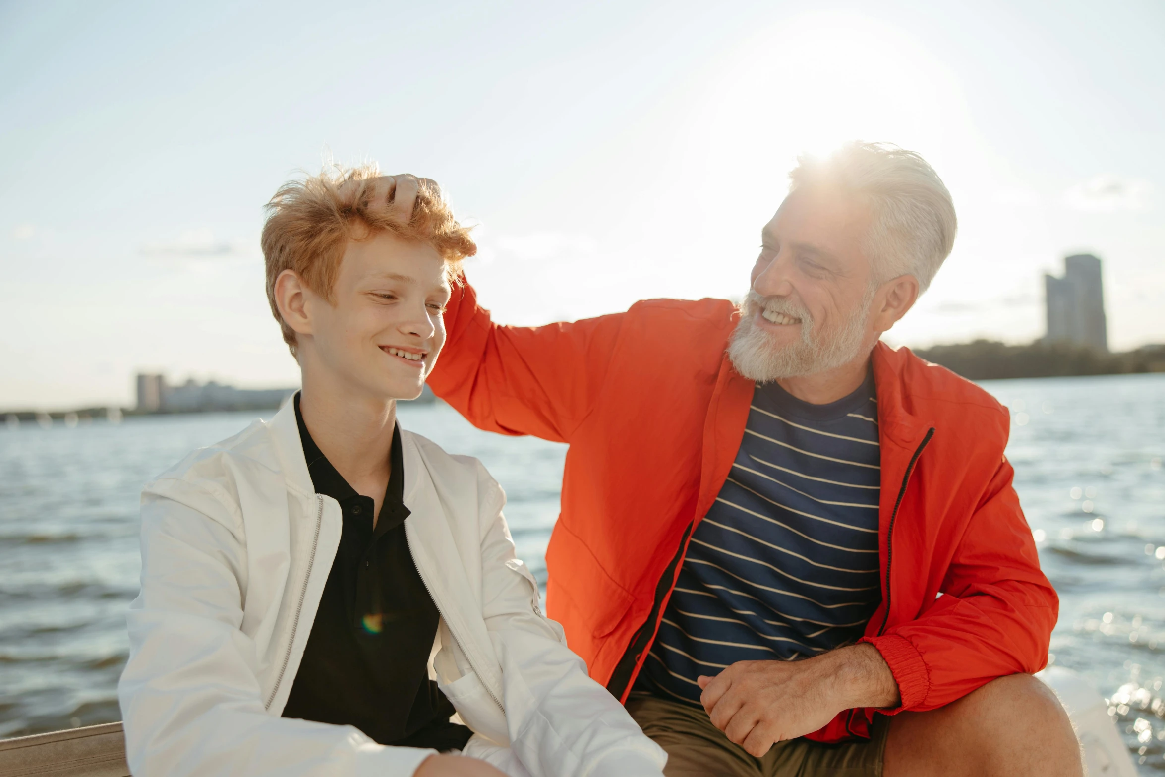 a little boy and an older man at the beach