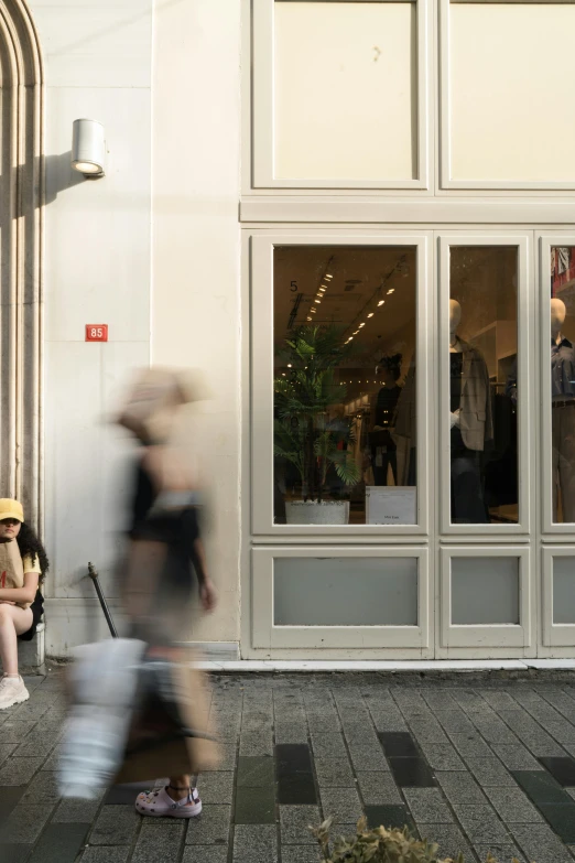 a blurry image of people sitting in front of a store