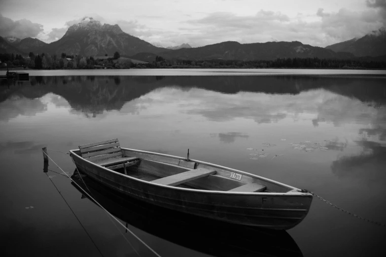 a boat is parked in a shallow, calm lake