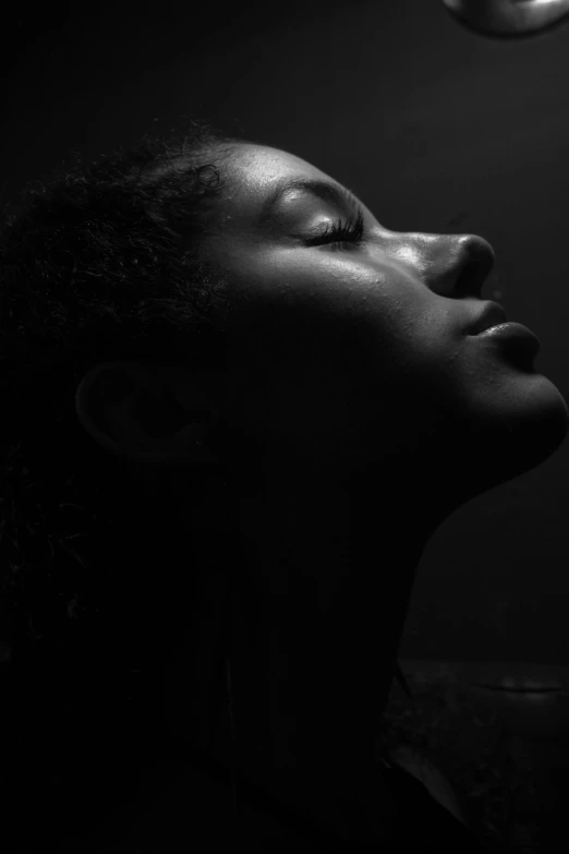 a woman's profile is shown as she rests her head and has one light on