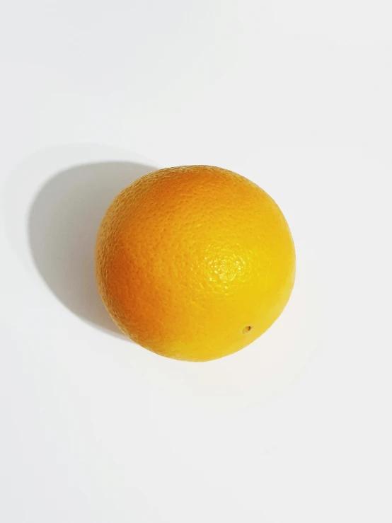 the orange is placed on a white table