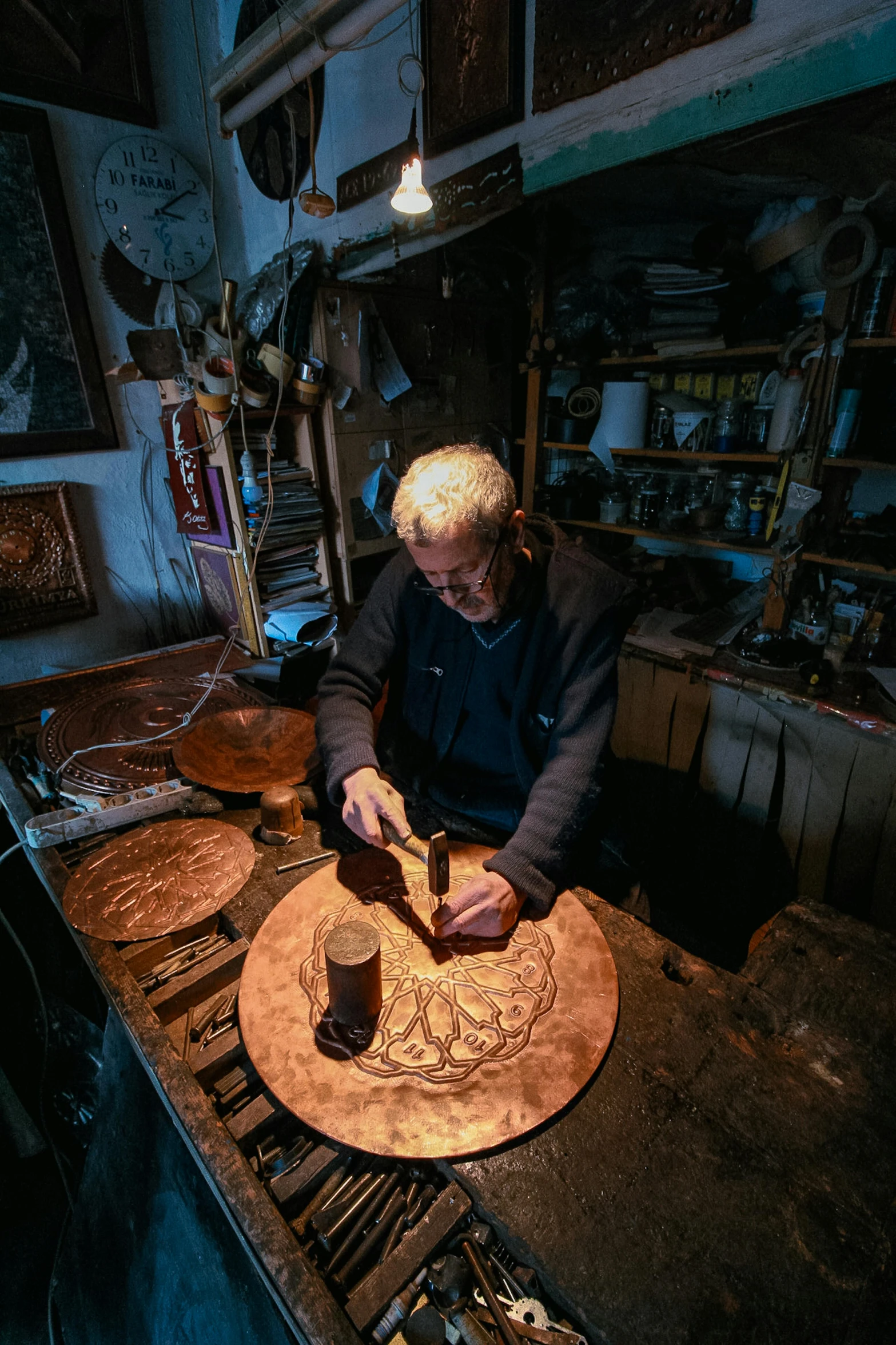 a man in his workshop working on wooden designs