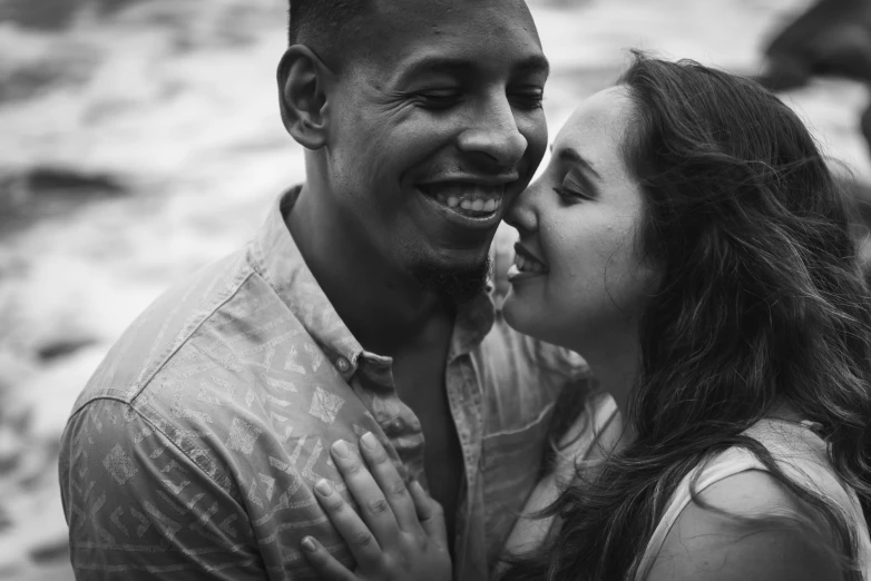 man and woman smiling at each other with their foreheads touching