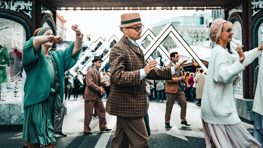 some people standing on the street dancing together