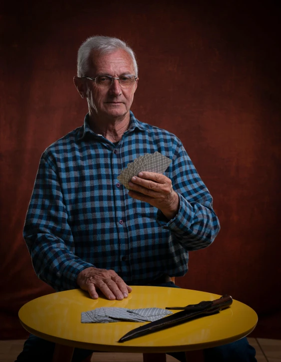 a man in glasses holding up a piece of cloth