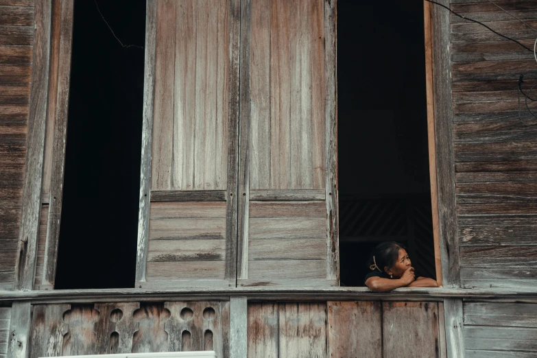 there is a woman looking out the window of a building