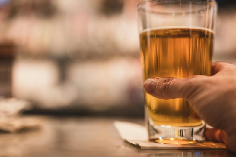 a person holding an alcoholic glass in their hand