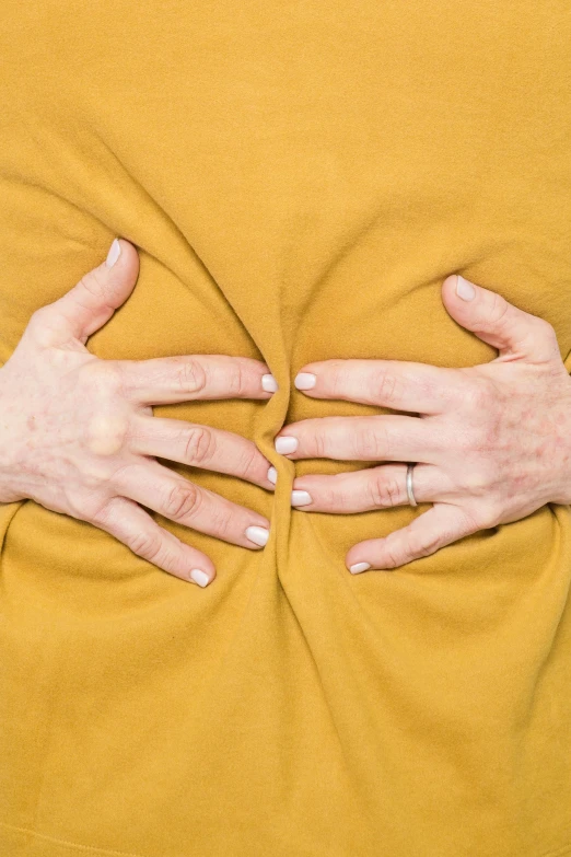 an image of a woman covering her stomach with her hands