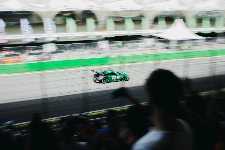 a man riding a motor bike down a racing track